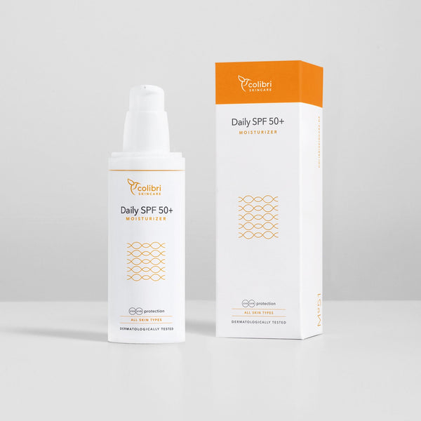 Flasche und Verpackung einer Tagescreme mit LSF 50+ von Colibri Skincare, gestaltet in Weiß und Orange.